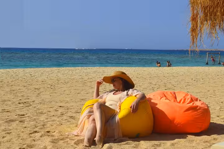 Relaxing on Eden Island beach near Hurghada with sea views, sun loungers, and Red Sea day trip lunch