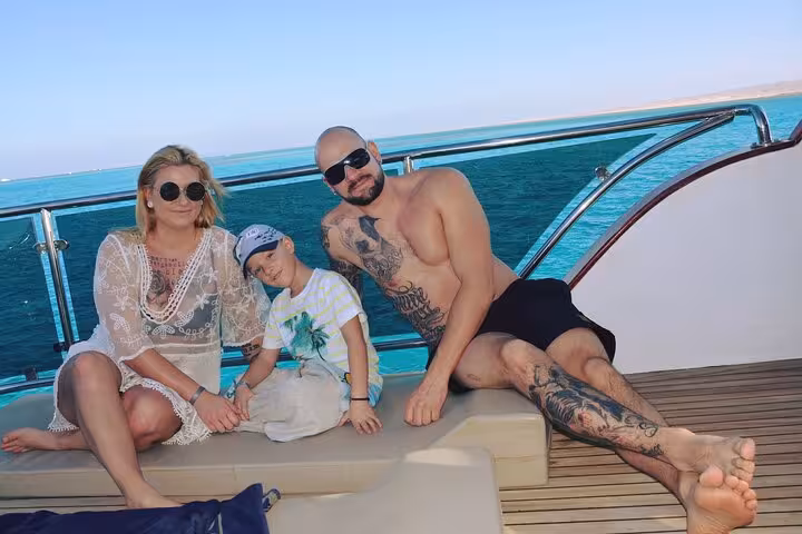 Family relaxing on yacht deck during Eden Island day trip from Hurghada, Red Sea cruise with water sports