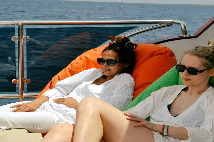 Guests relaxing on yacht beanbags during Eden Island day trip from Hurghada, Red Sea cruise with lunch