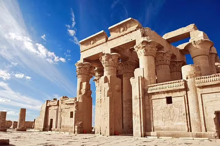 Edfu Temple entrance pylons and columns under blue sky on Luxor to Edfu and Kom Ombo day tour