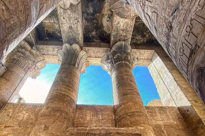 Edfu Temple hypostyle hall columns and carved ceiling seen from below on Luxor day tour to Edfu and Kom Ombo