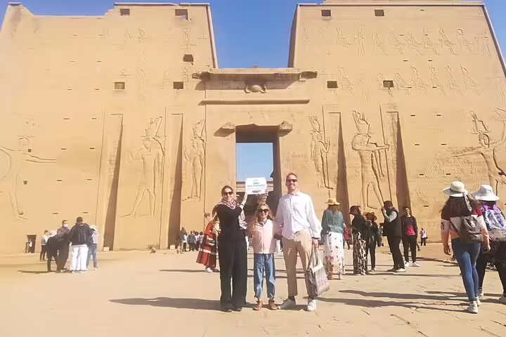 Visitors at Edfu Temple pylon on private Luxor tour from Cairo by plane, Egypt Nile Valley day trip