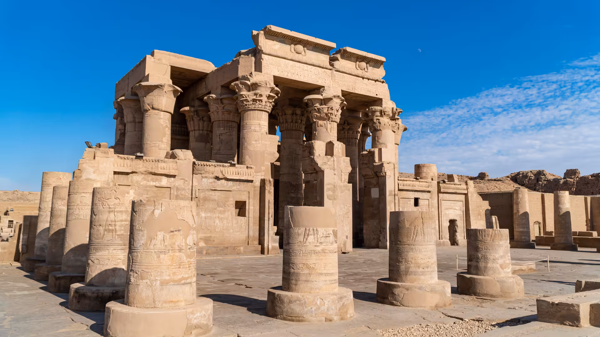 Edfu Temple sandstone columns under blue sky, must-see stop on an 8-day budget Nile cruise from Luxor to Aswan
