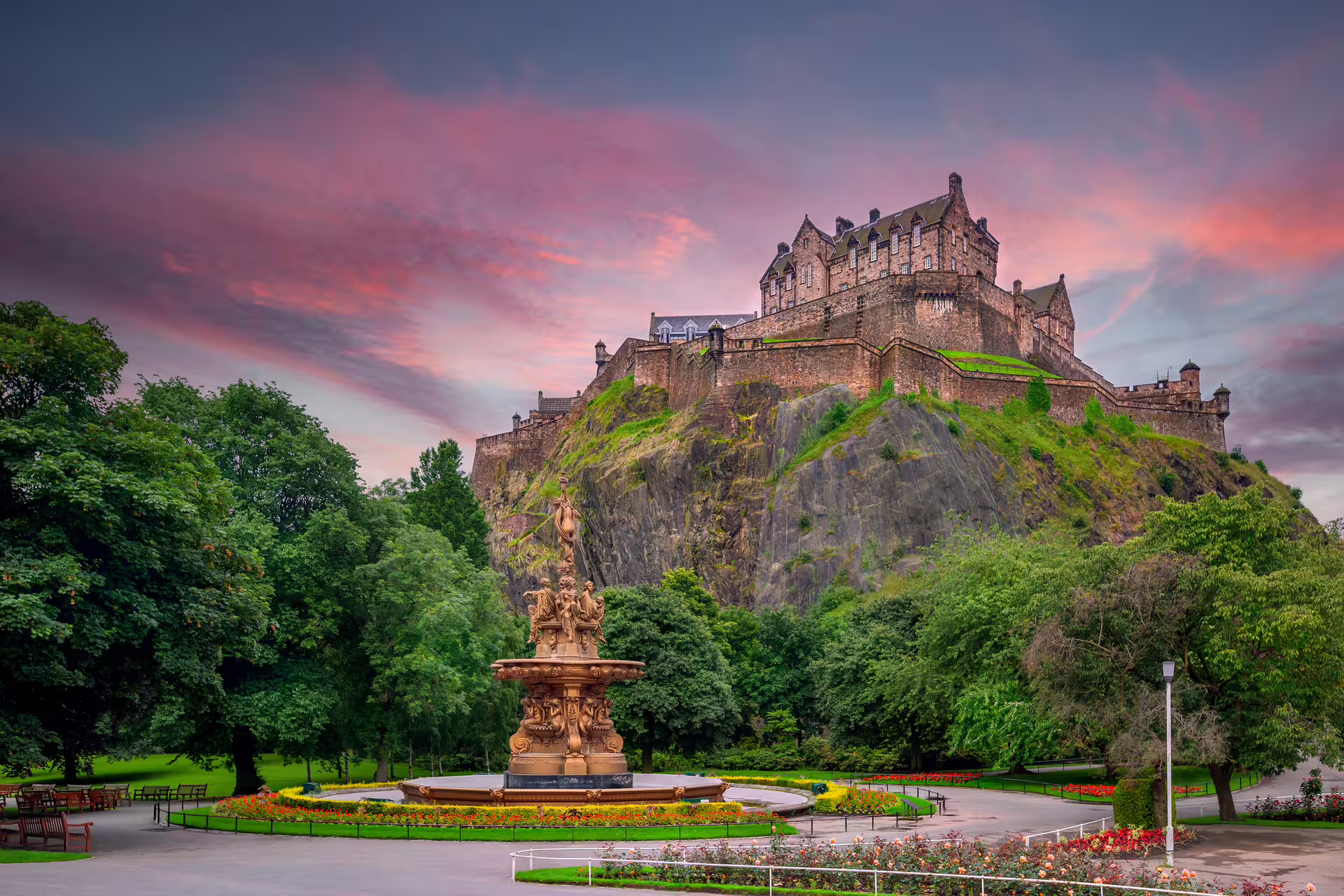 Edinburgh Castle at sunset from Princes Street Gardens on an Edinburgh in 1 day walking tour audioguide