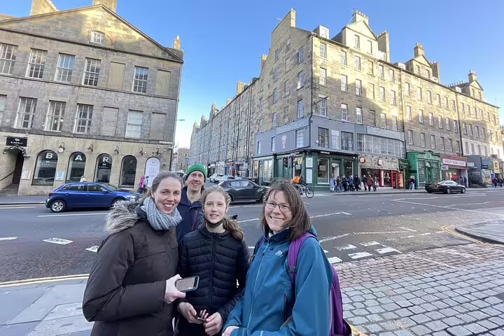 Family posing on Edinburgh's Royal Mile during Harry Potter self-guided walking tour on sunny day