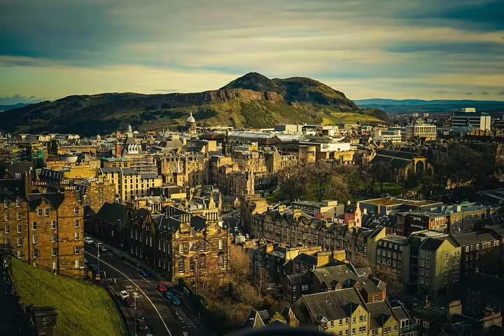 Edinburgh skyline with Arthur’s Seat at sunset, gateway city view before a Glencoe and Highlands Adventure tour