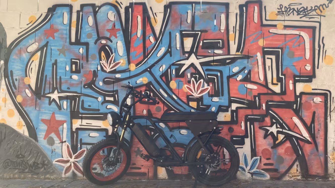 E-fat bike rental parked by colorful street art mural, ideal for 4-hour coastal trails and city views