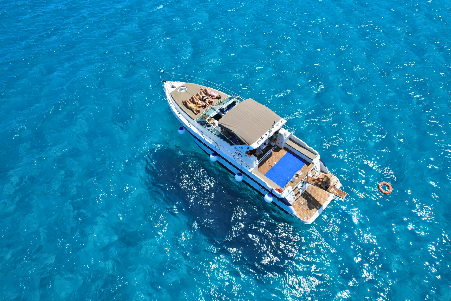 Boat excursion in the Egadi Islands near Favignana, cruising turquoise sea with sun deck and lunch from Trapani