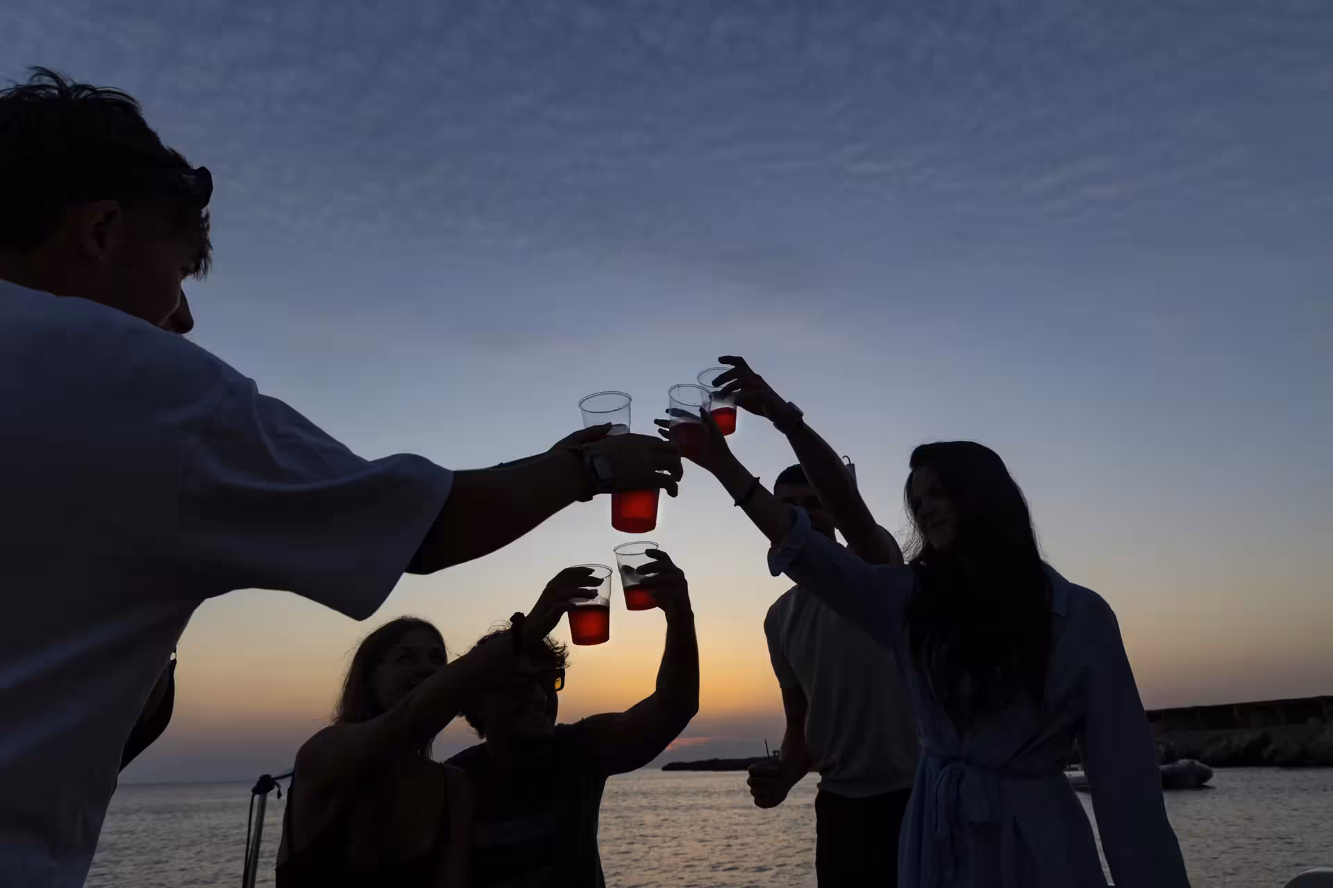 Sunset toast on boat during Egadi Islands tour from Trapani, Favignana and Levanzo cruise with lunch