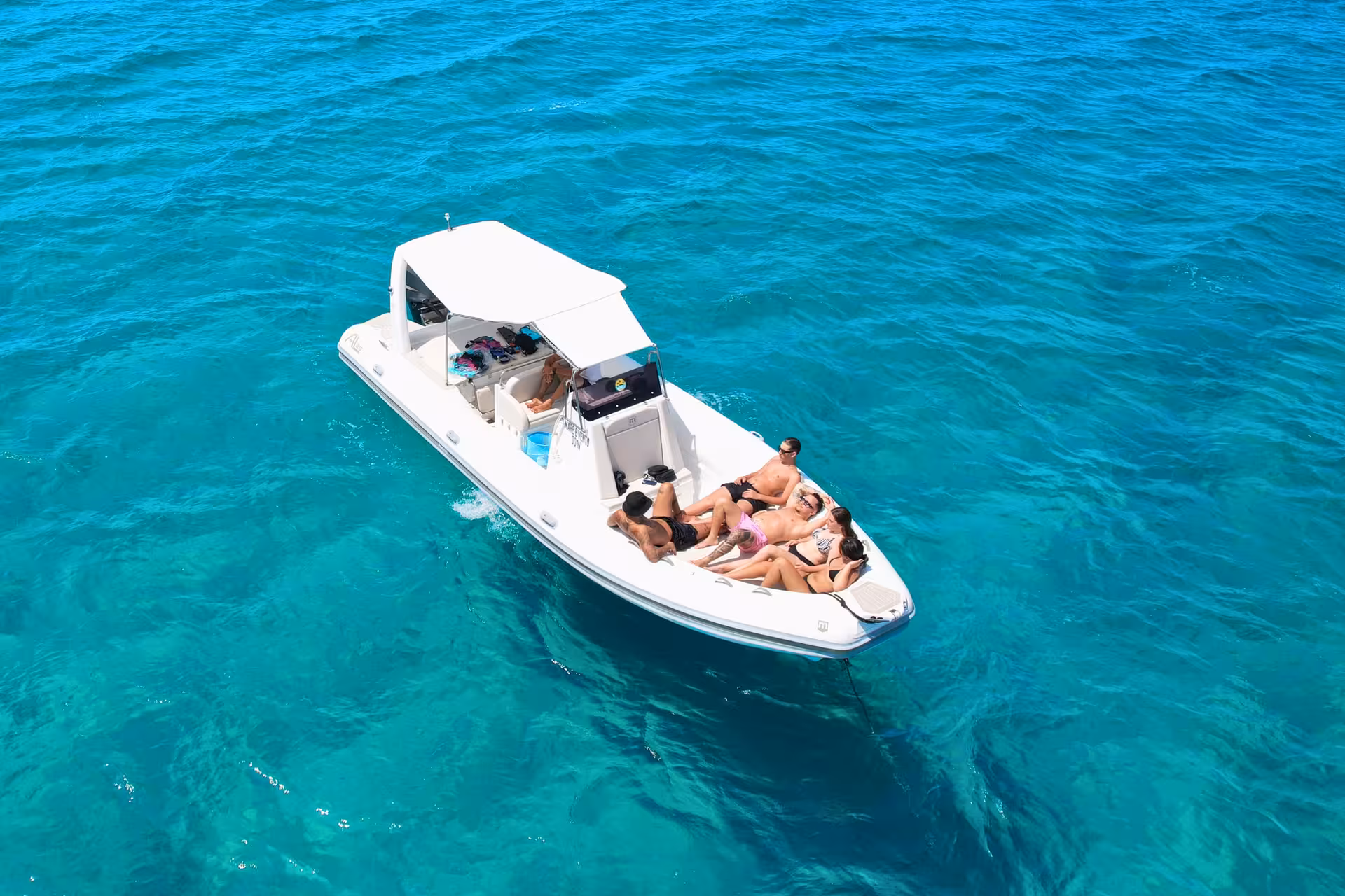Aerial view of private dinghy in turquoise Egadi Sea near Favignana and Levanzo, Trapani tour with lunch