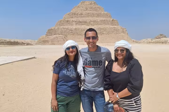 Tourists standing in front of the Step Pyramid of Djoser, showcasing highlights of the 11-day Egypt adventure with Nile cruise.