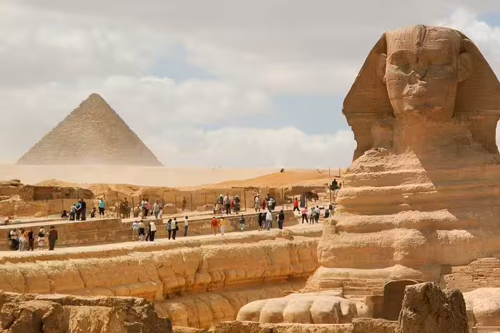 Great Sphinx and Giza Pyramid plateau with visitors, must-see on 5-day Egypt short break small group