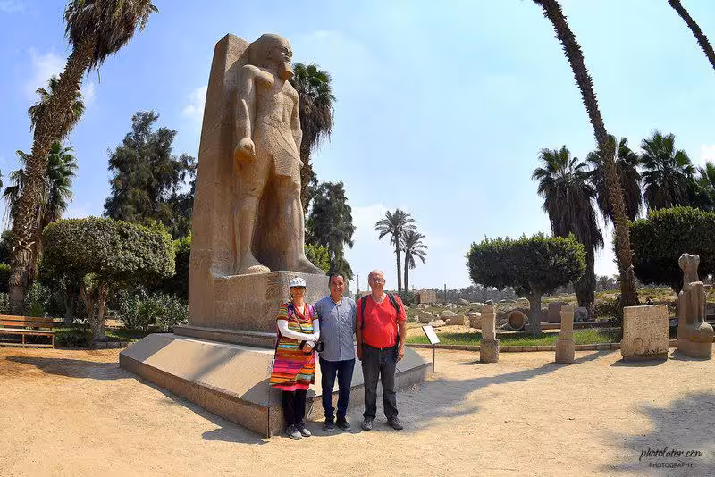 Travelers pose by a colossal ancient statue in Cairo, a highlight of the 4-day private Egypt tour