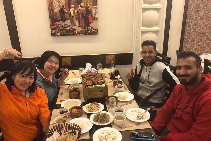 Tour guests enjoying traditional Egyptian lunch after Great Pyramid, Sphinx and Saqqara Serapeum visit