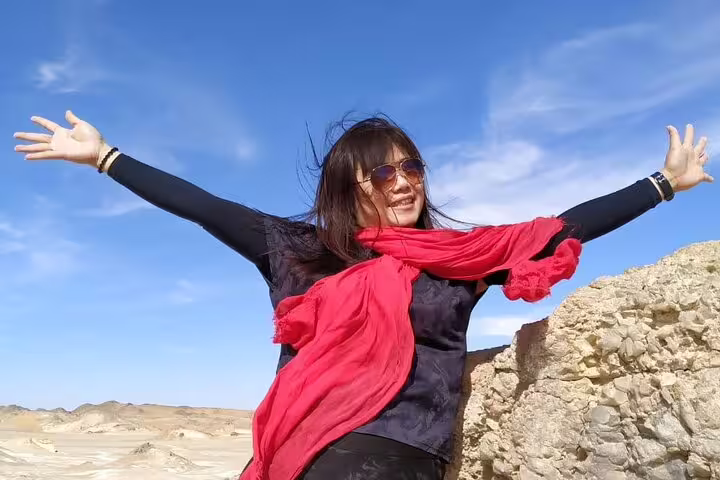 Happy traveler with red scarf in Egypt’s White Desert, part of a 2-day Black and White Desert jeep camp tour