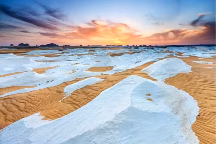 Sunset over Egypt White Desert with chalk rock formations and dunes, a highlight on a 15-day Cairo and Nile cruise tour