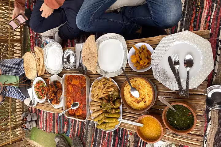 Traditional Egyptian farm lunch spread served on a rustic table in Dahshur countryside with local hosts