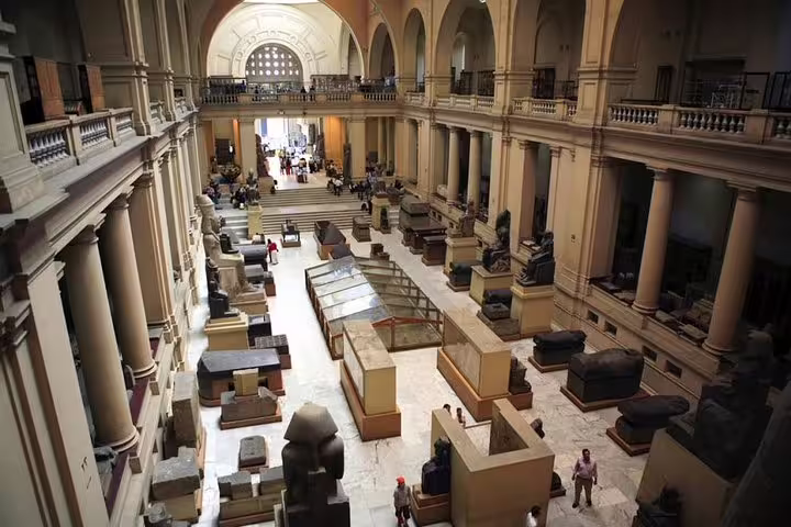 Egyptian Museum Cairo interior with ancient statues and sarcophagi, included in 3-day private Cairo tour