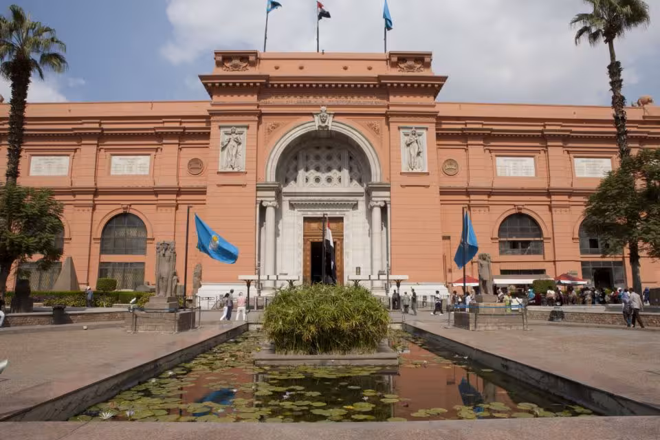 Front entrance of the Egyptian Museum Cairo on a private tour, with reflecting pool and visitors