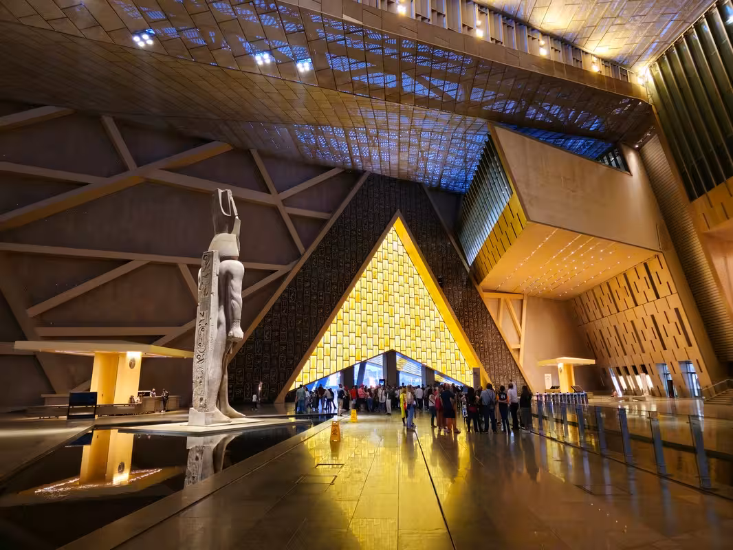 Grand Egyptian Museum Cairo atrium with pharaoh statue and glowing entrance on 5-star 8-day itinerary