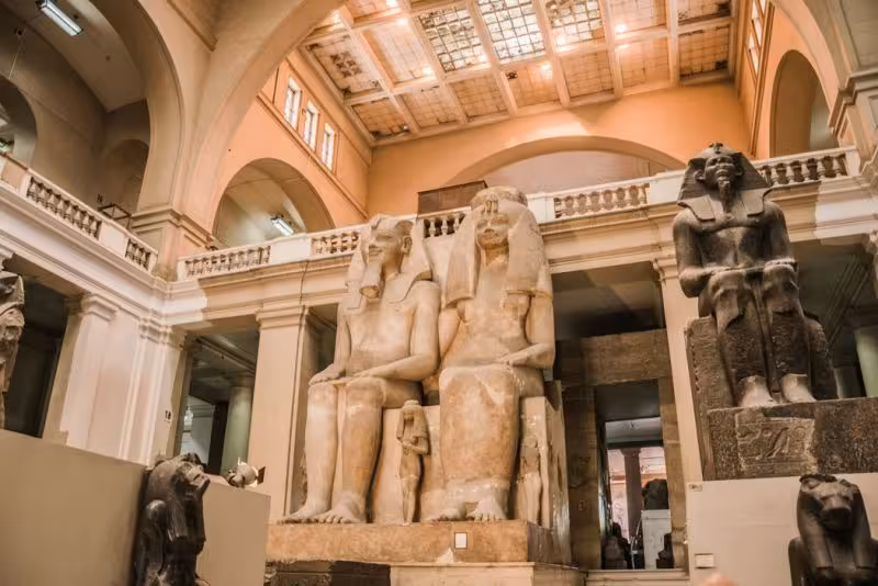 Grand hall inside the Egyptian Museum Cairo with colossal pharaoh statues on a private guided museum tour