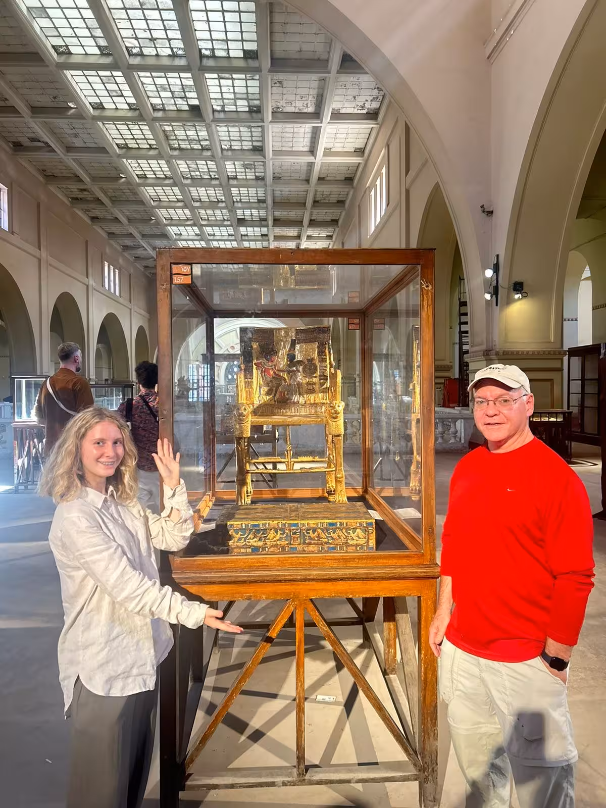 Tourists at the Egyptian Museum Cairo viewing a gilded pharaonic throne on a 4-day private Egypt tour