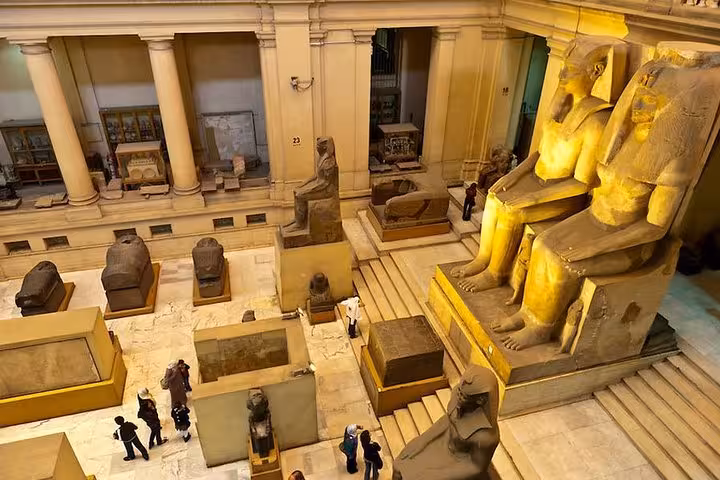 Grand Egyptian Museum Cairo statues and sarcophagi hall, key stop on Hurghada to Cairo day tour