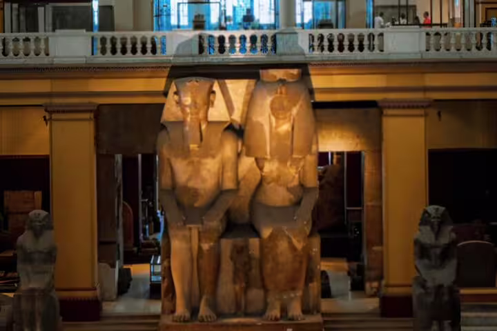 Colossal ancient Egyptian statues inside Egyptian Museum Cairo on Alexandria Port National Museum guided tour