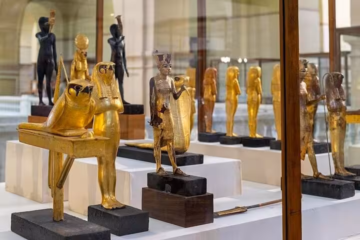 Golden ancient Egyptian statues inside the Egyptian Museum Cairo, highlight of private tour with Citadel and Old churches