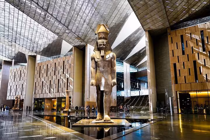 Grand Egyptian Museum atrium with colossal pharaoh statue, highlight of VIP Giza & GEM Tour near the Pyramids