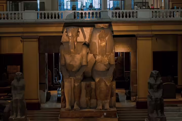 Colossal pharaoh statues inside the Egyptian Museum in Cairo, featured on Luxor to Cairo and Alexandria flight tour