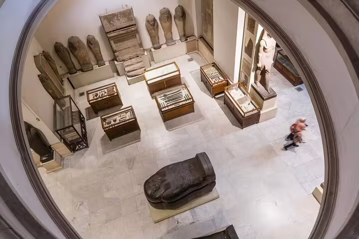 Egyptian Museum gallery with sarcophagi and ancient artifacts, Cairo day trip from El Sokhna Port with guide