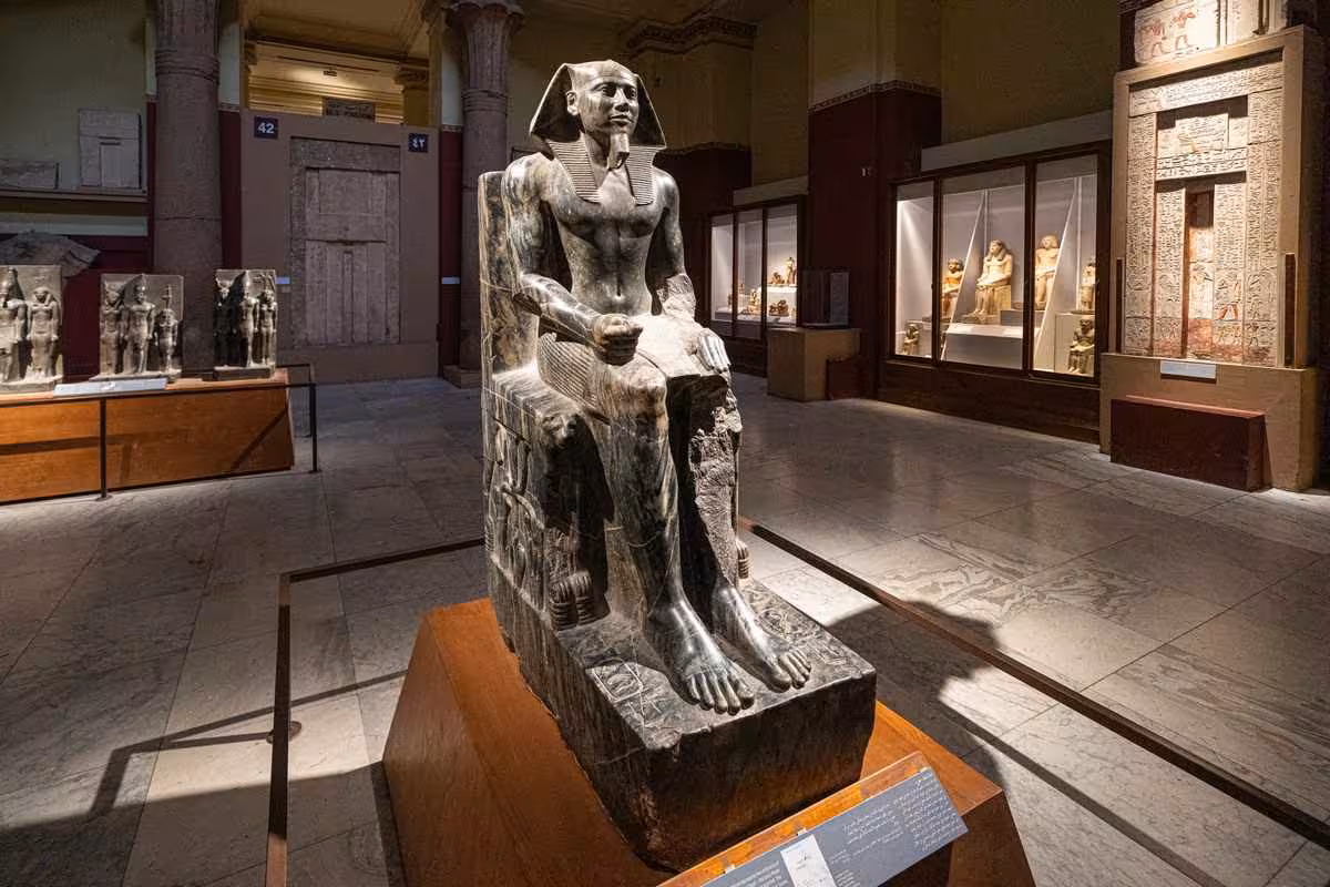 Seated ancient Egyptian pharaoh statue in Cairo Egyptian Museum on a private guided museum tour
