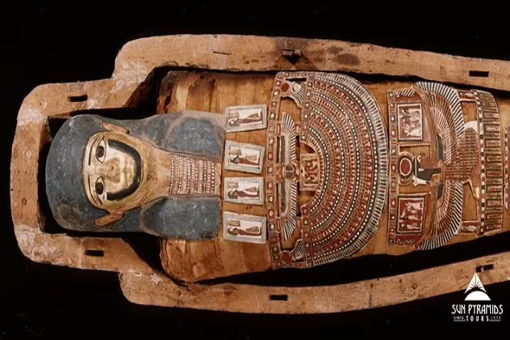 Painted ancient Egyptian sarcophagus displayed in Cairo museum, key stop on a day tour from Alexandria to Cairo