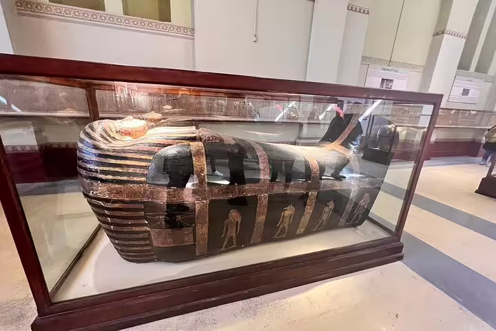 Ancient Egyptian sarcophagus exhibit at Cairo Egyptian Museum on Giza Pyramids day tour from Sharm by bus