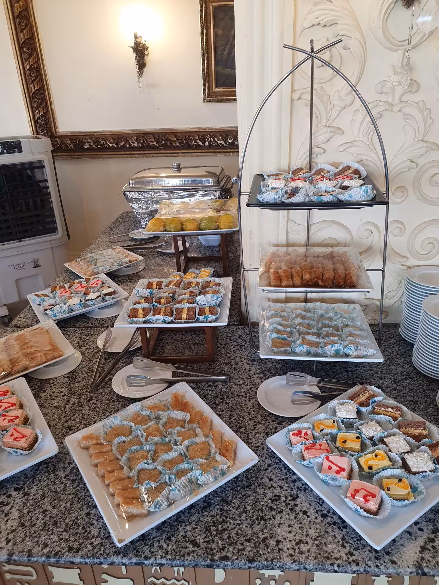 Assorted Egyptian pastries and sweets displayed on platters at a buffet spread