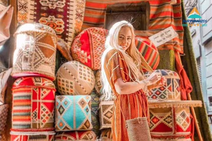 Traveler shopping colorful Egyptian textiles in Cairo bazaar, part of 15-day Pyramids Luxor Aswan Oasis tour