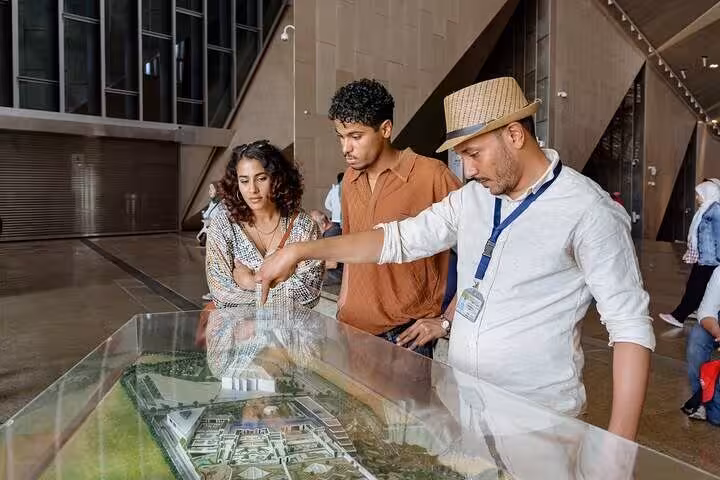 Expert Egyptologist briefing guests at the Grand Egyptian Museum on a Hurghada to Cairo private tour