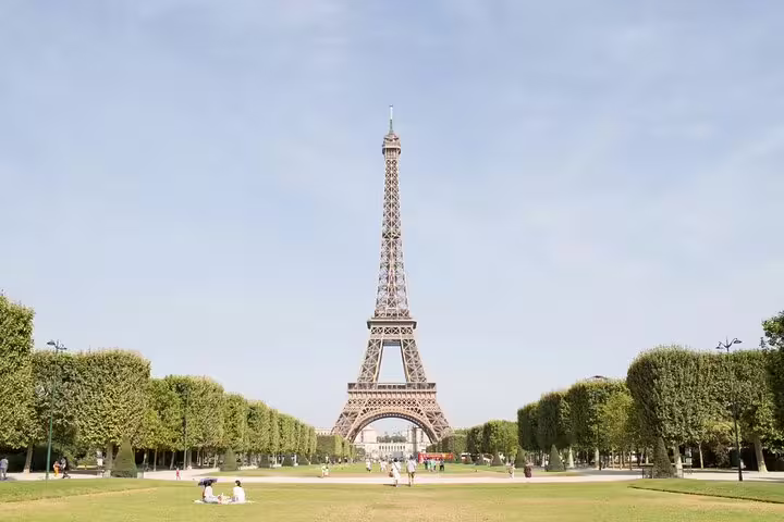 Eiffel Tower viewed from Champ de Mars gardens on a sunny day in Paris