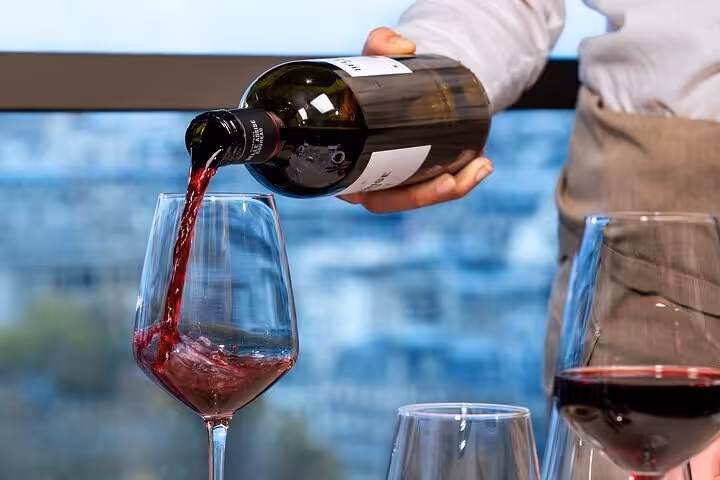 Red wine poured during luxury Eiffel Tower lunch experience on a private Paris tour with Seine cruise