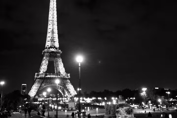 Eiffel Tower illuminated at night with city lights in Paris