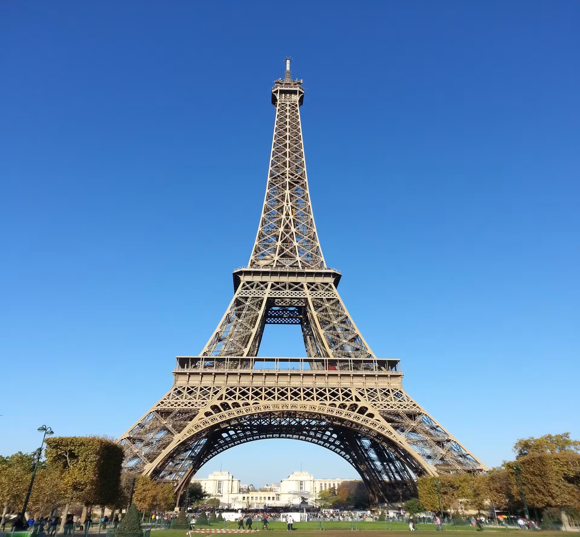 Eiffel Tower against a clear blue sky viewed from Champ de Mars, Paris