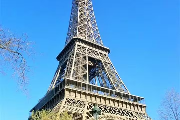 Eiffel Tower steel lattice structure against clear blue sky in Paris