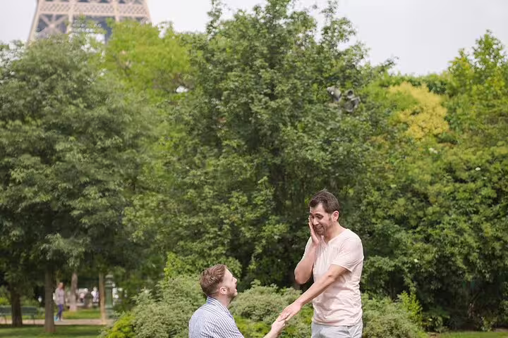 Man proposing to partner near Eiffel Tower in Paris park