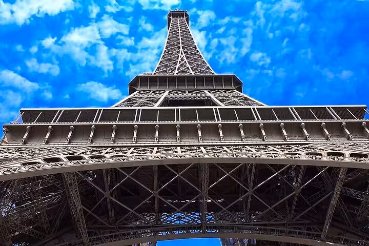 Upward view of the Eiffel Tower on a private Paris tour with luxury lunch and Seine cruise