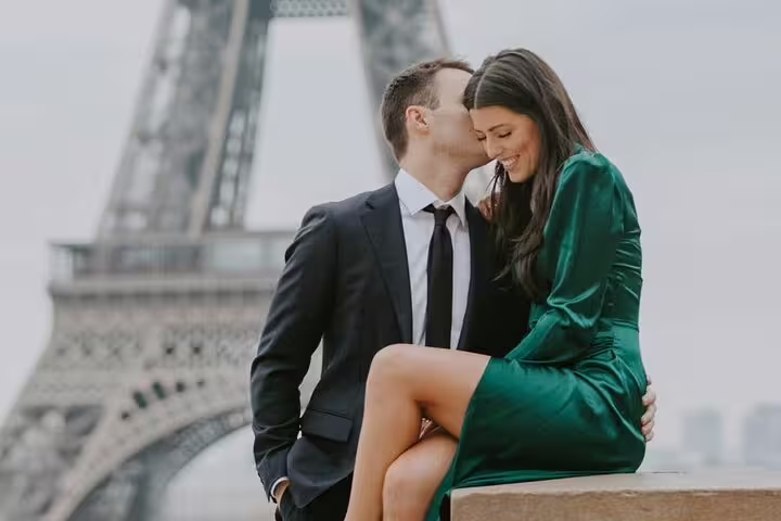 Couple sharing a romantic moment in front of the Eiffel Tower in Paris