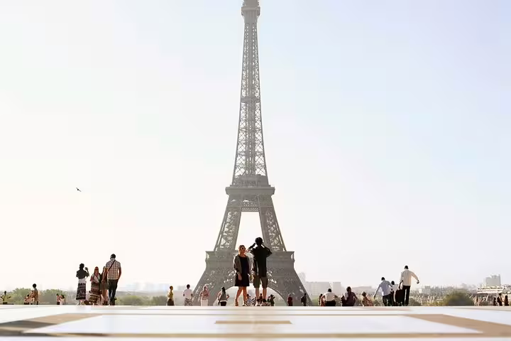 Tourists at Trocadero plaza with Eiffel Tower summit view in Paris