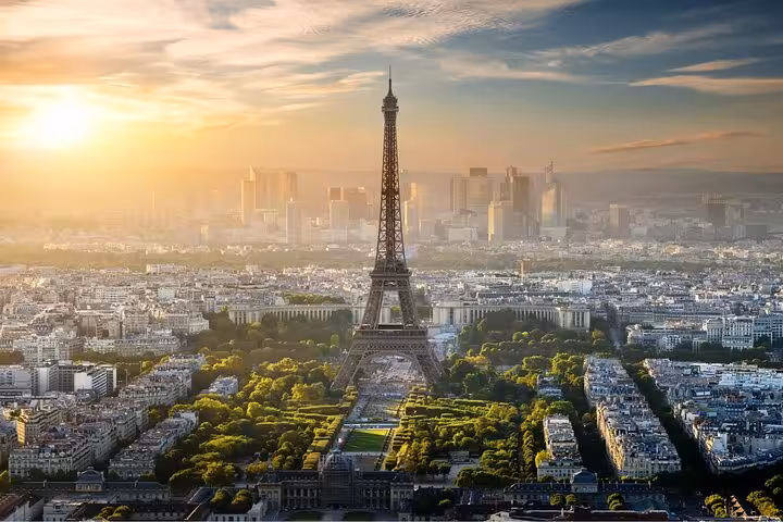 Sunrise view of the Eiffel Tower over Paris, perfect for a private luxury Eiffel Tower lunch and Seine cruise