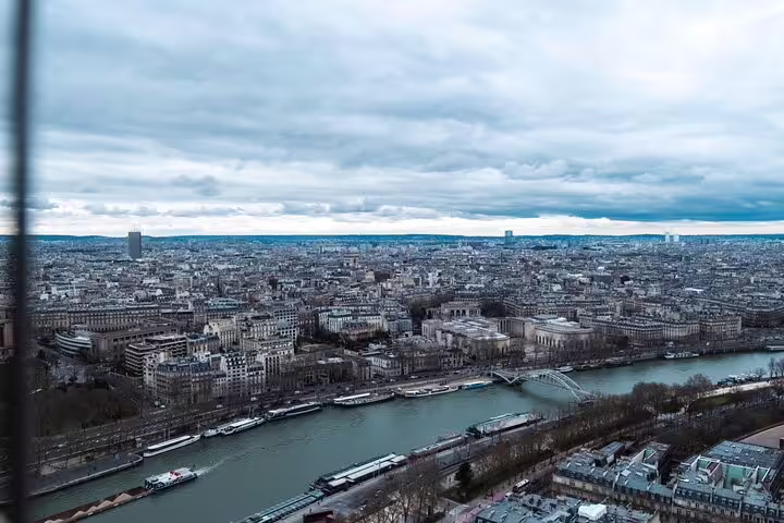 Aerial view of Paris and the Seine River from the Eiffel Tower top floor on a cloudy day