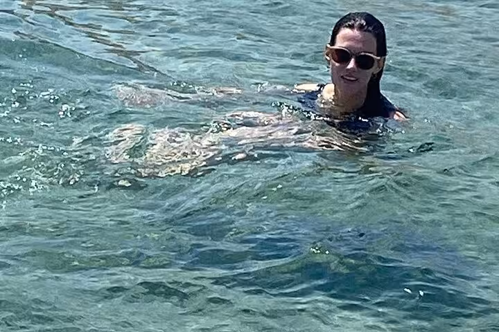 Traveler swimming in clear Red Sea water on El Ain El Sokhna day tour from Cairo, Egypt beach escape
